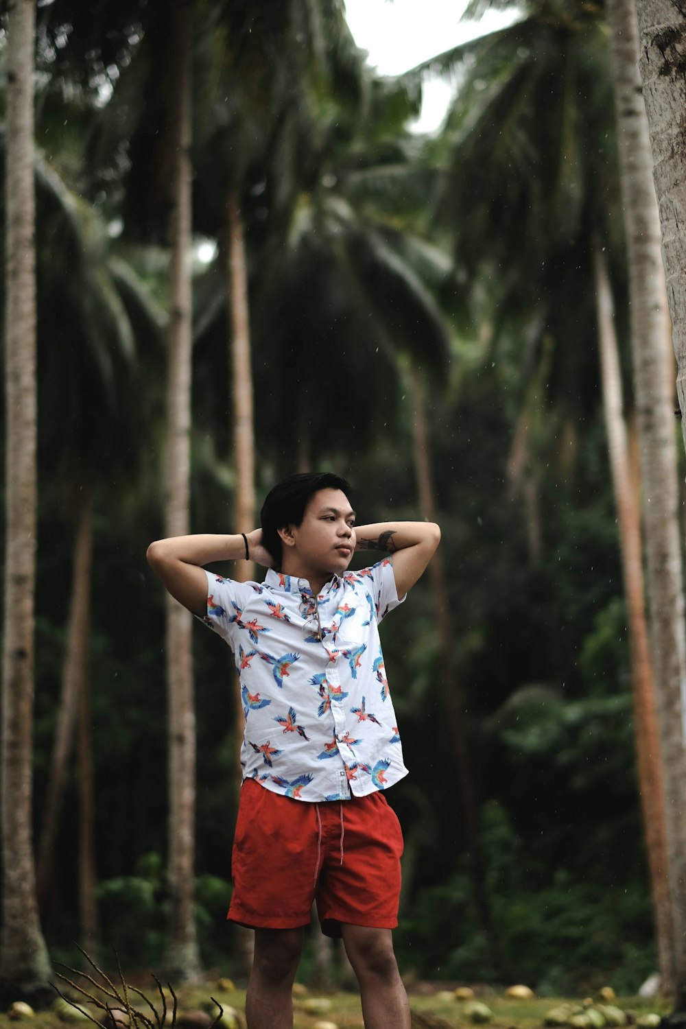 boy standing near trees
