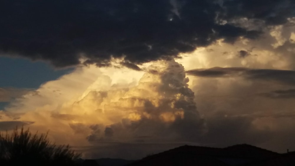 silhouette of mountain under white clouds