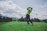 photo of man swinging golf driver