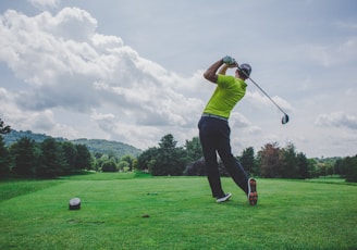 photo of man swinging golf driver