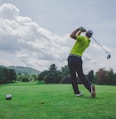 photo of man swinging golf driver