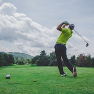 photo of man swinging golf driver