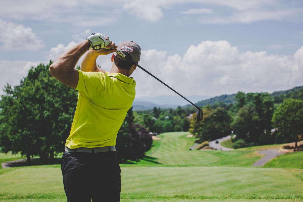 man playing golf during daytime