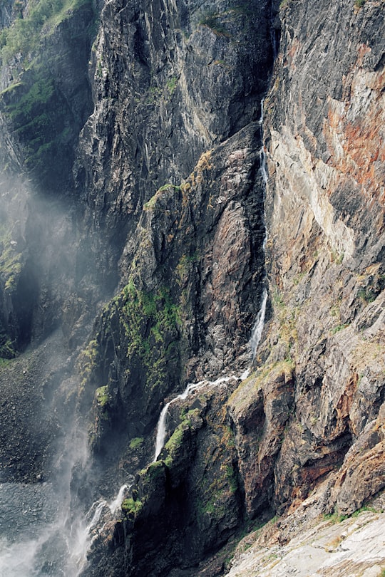 brown stone hill at daytime in Vøringfossen Norway