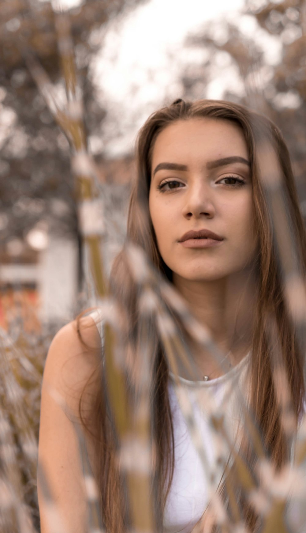 deep of field photography of woman beside grasses