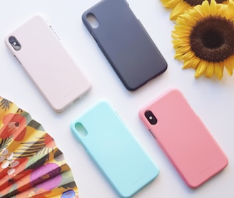 four assorted-color iPhone X cases