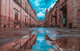 empty alley with buildings on side under blue sky