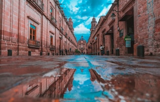 empty alley with buildings on side under blue sky