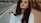 woman in white sweater taking selfie