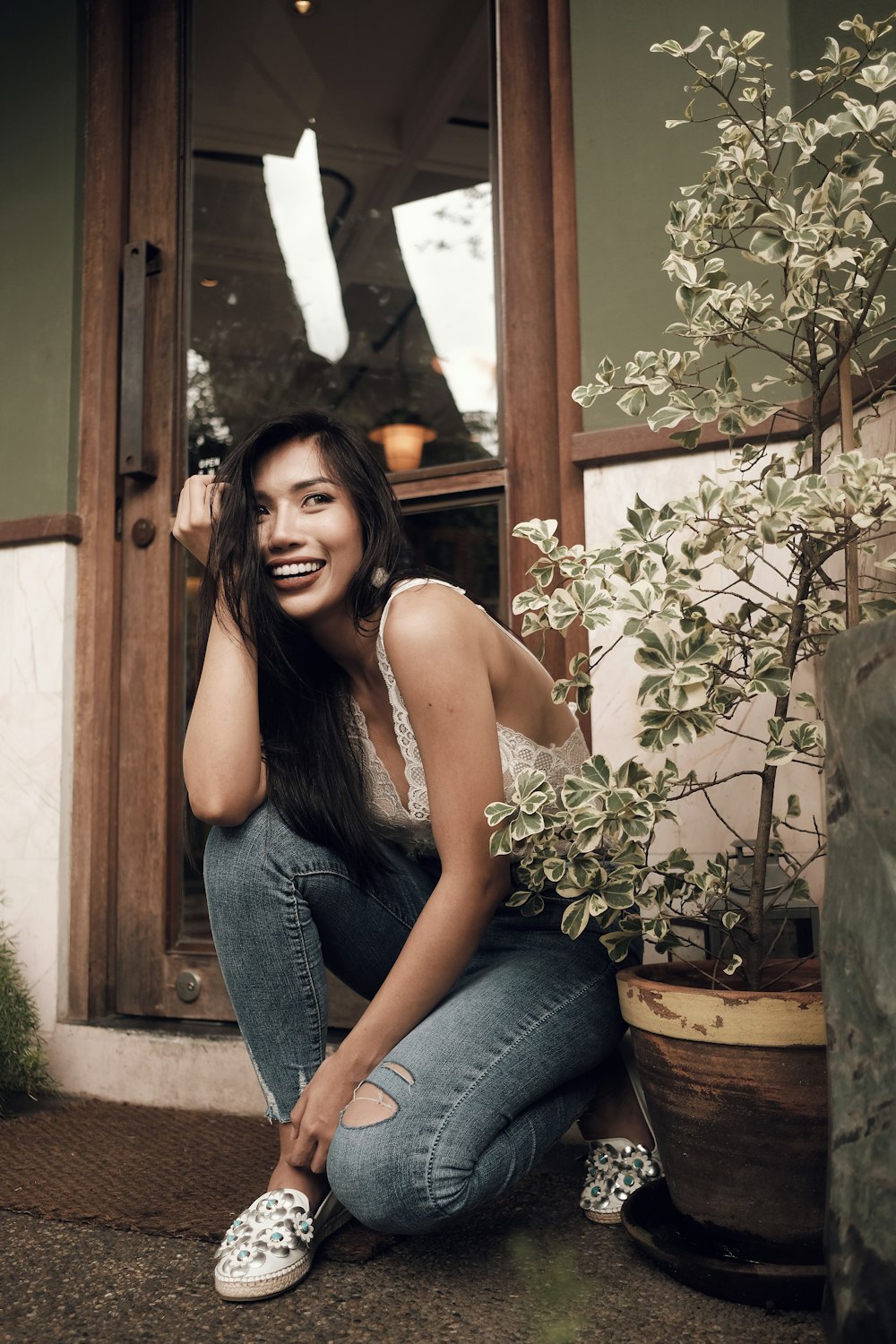 woman sitting beside glass door