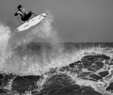 grayscale man surfing