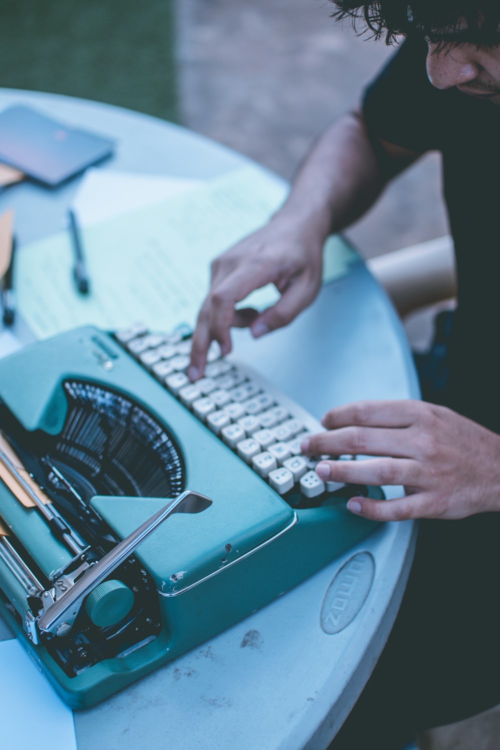 man using gray and white typewriter