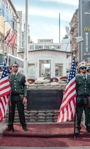 two men holding USA flags outdoors