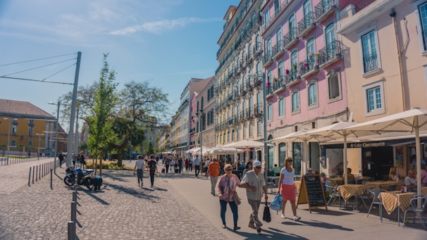 A bustling street scene in Berlin with colorful buildings and people enjoying a sunny day.