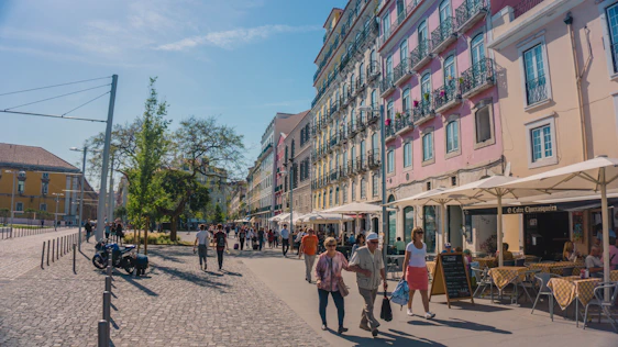 A bright, inviting street scene in Milan with locals and tourists enjoying a sunny day near the Duomo.