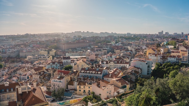 A serene landscape of a Belgian city with a hint of Brazilian culture, featuring colorful street art and traditional architecture.