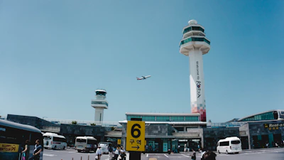 A welcoming scene at the airport with a consultant greeting new students arriving in South Korea.
