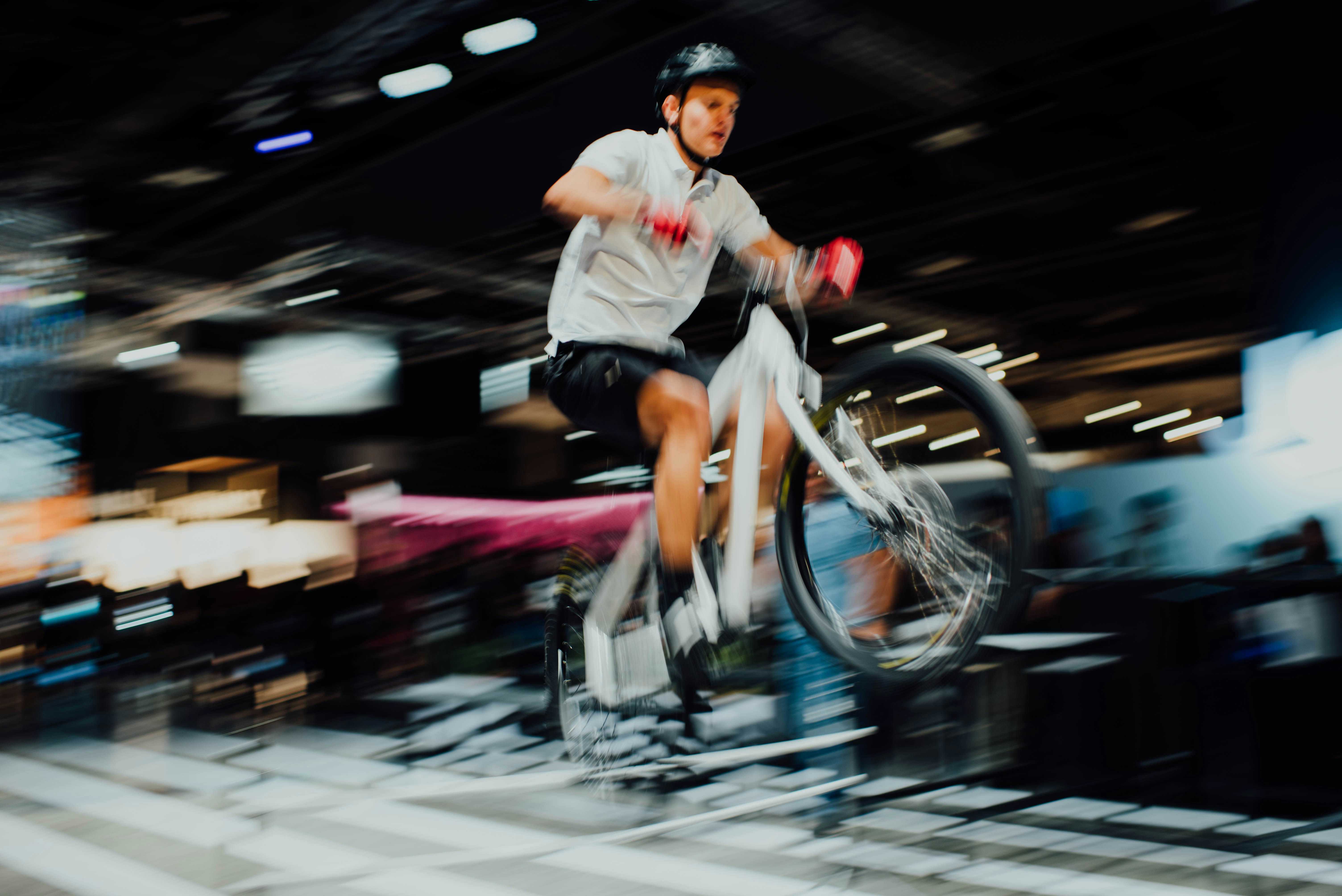 man riding white bike