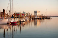 A serene marina scene with boats ready to sail after maintenance.