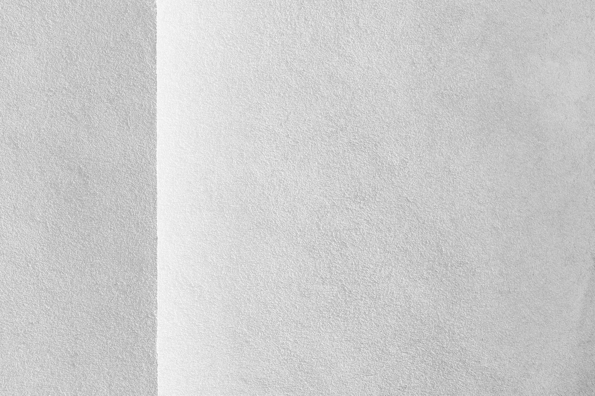 a black and white photo of a white wall