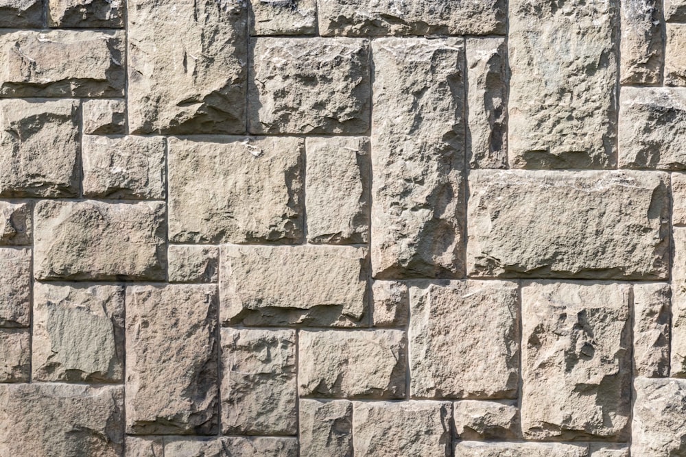 a close up of a wall made of stone blocks