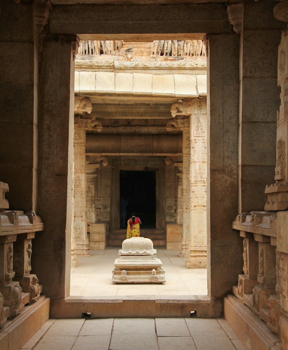 woman standing inside brown concrete structure