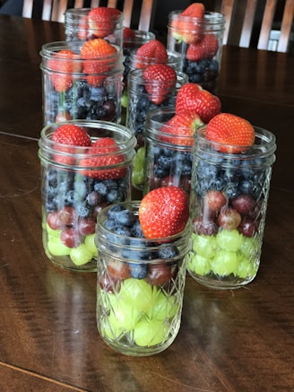 Canned fruit jars neatly arranged on a wooden table