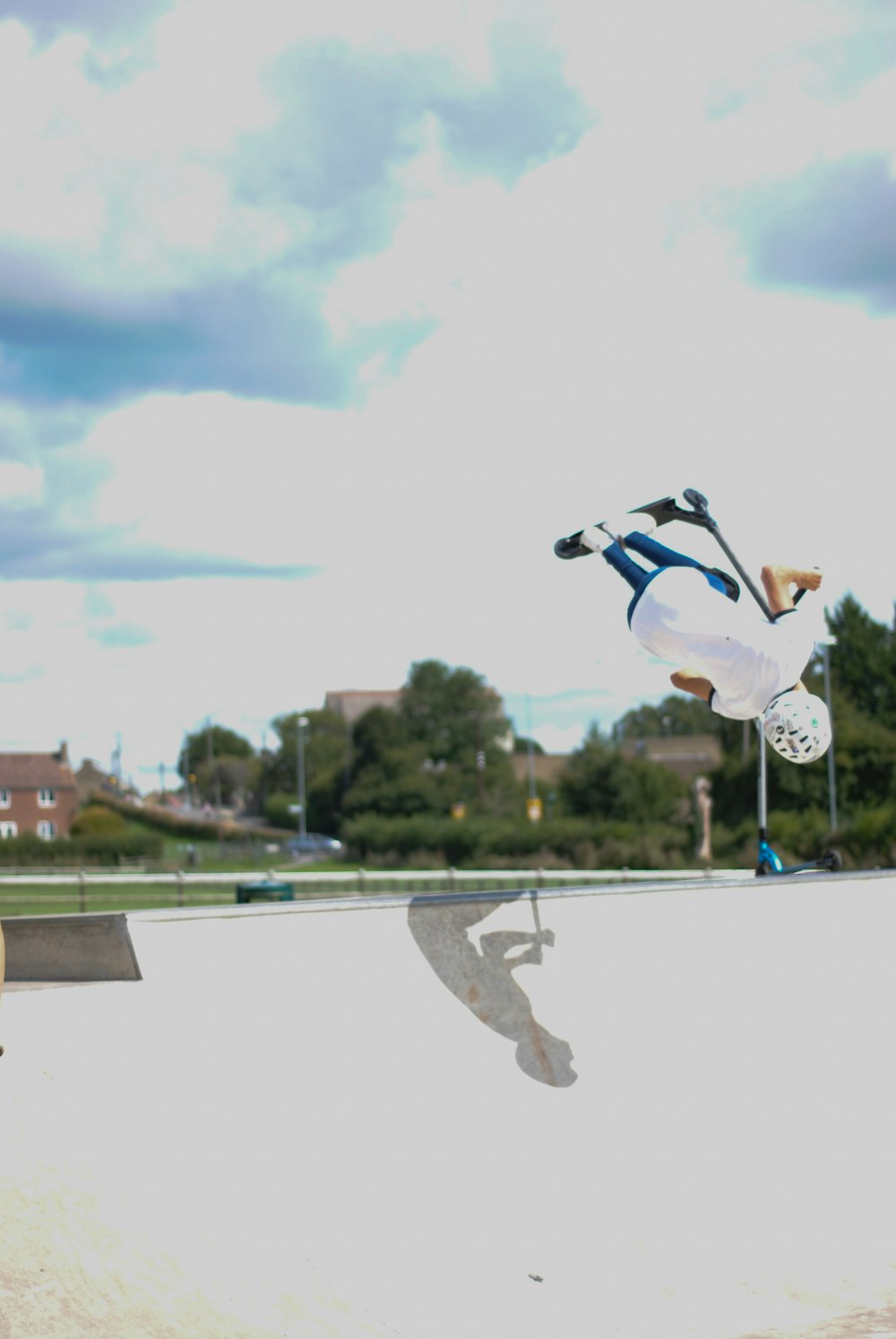 person in white t-shirt skateboarding at the skate park