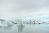 A serene iceberg glowing under the soft Antarctic sunset