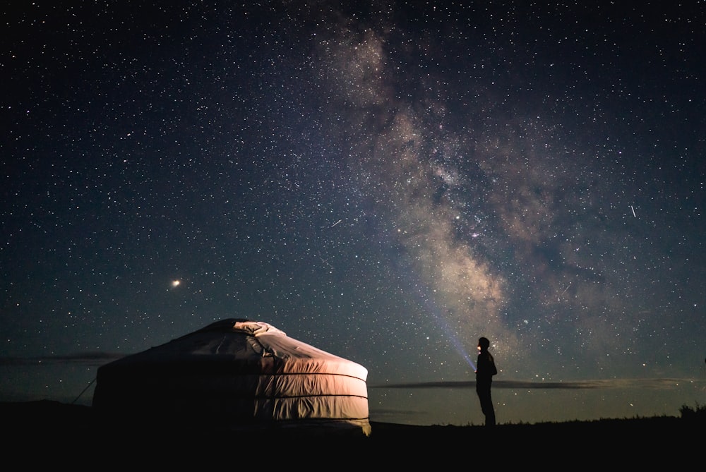 person standing beside tent