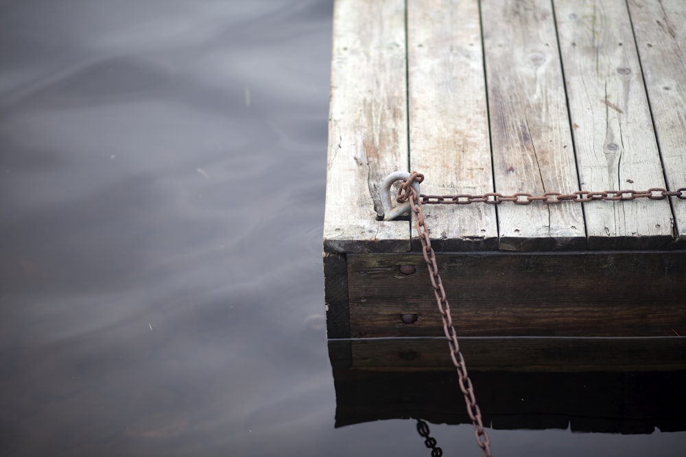 brown wooden board with chain