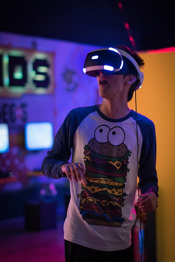 A young man uses a VR headset to play games in his home