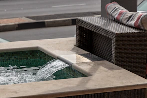 A custom-designed pool featuring natural stone decking and a cascading water feature.