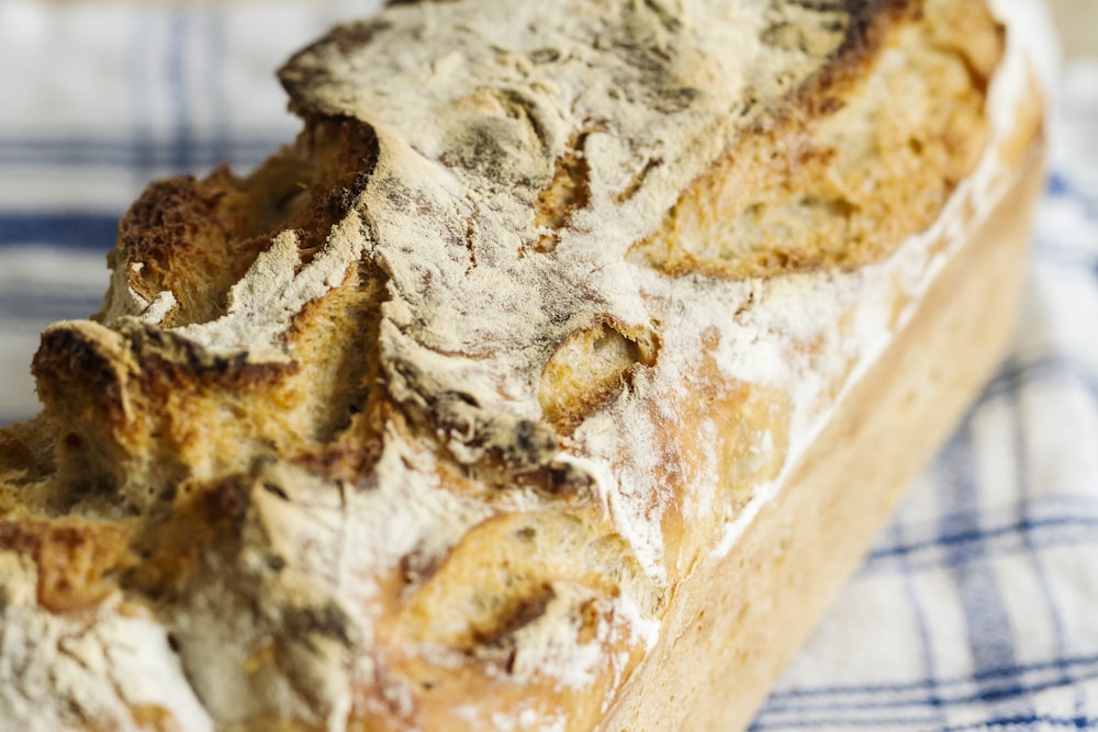 close-up photo of bread on white and blue plaid textile