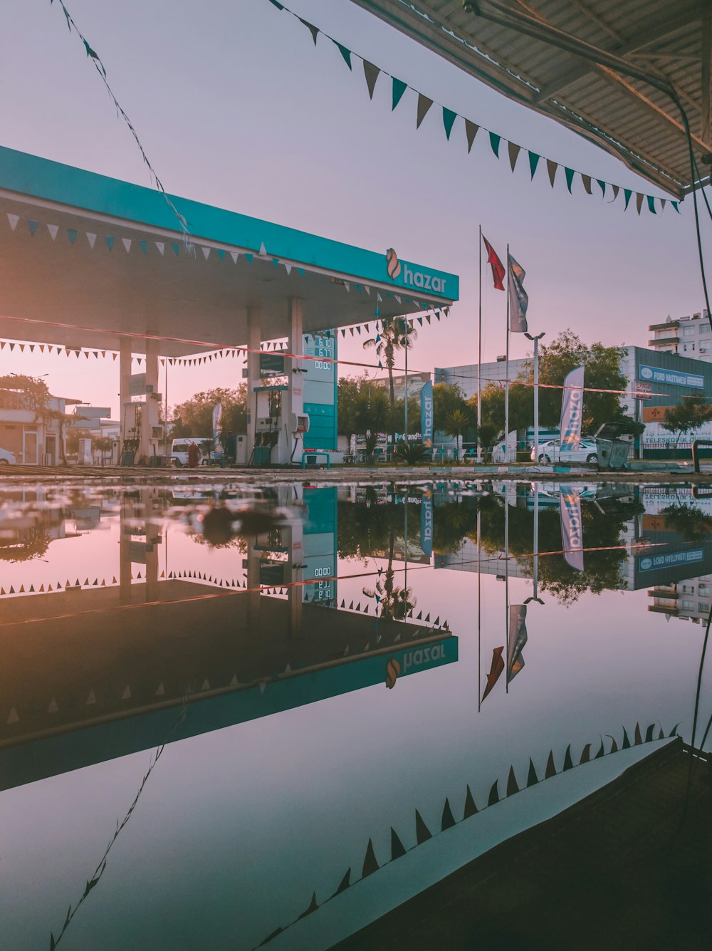 teal Hazar gasoline station under gray sky