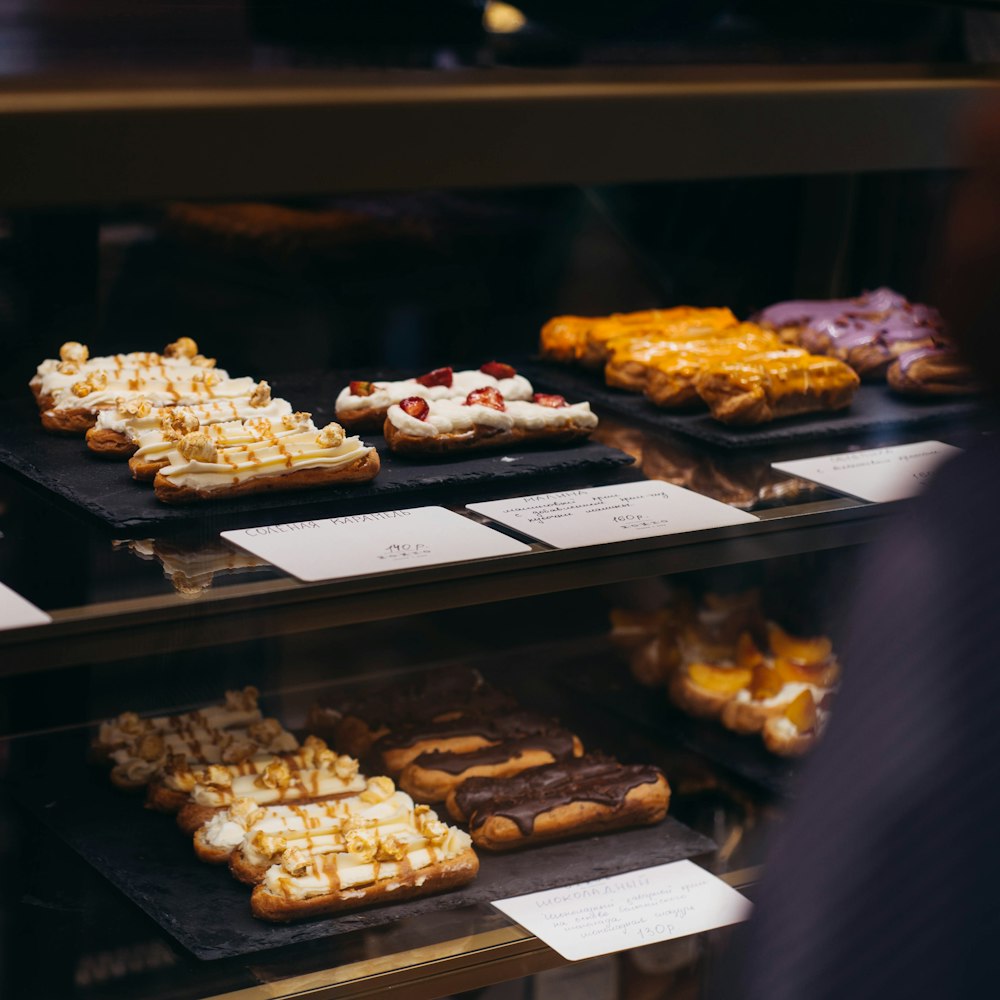 brown and white pastries on black tray