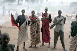 four men holding assault rifles