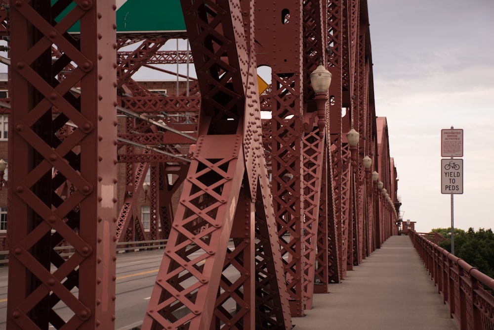 white signage mounted on bridge side walk