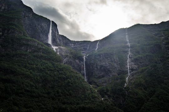 green mountain under cloudy sky in Gudvangen Norway