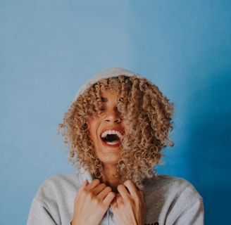 smiling woman wearing gray hoodie