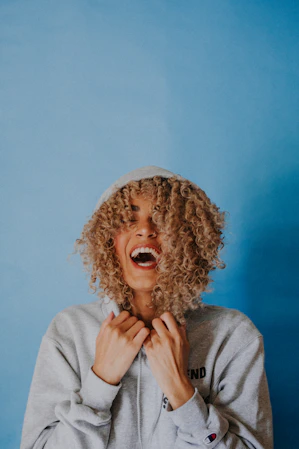 smiling woman wearing gray hoodie