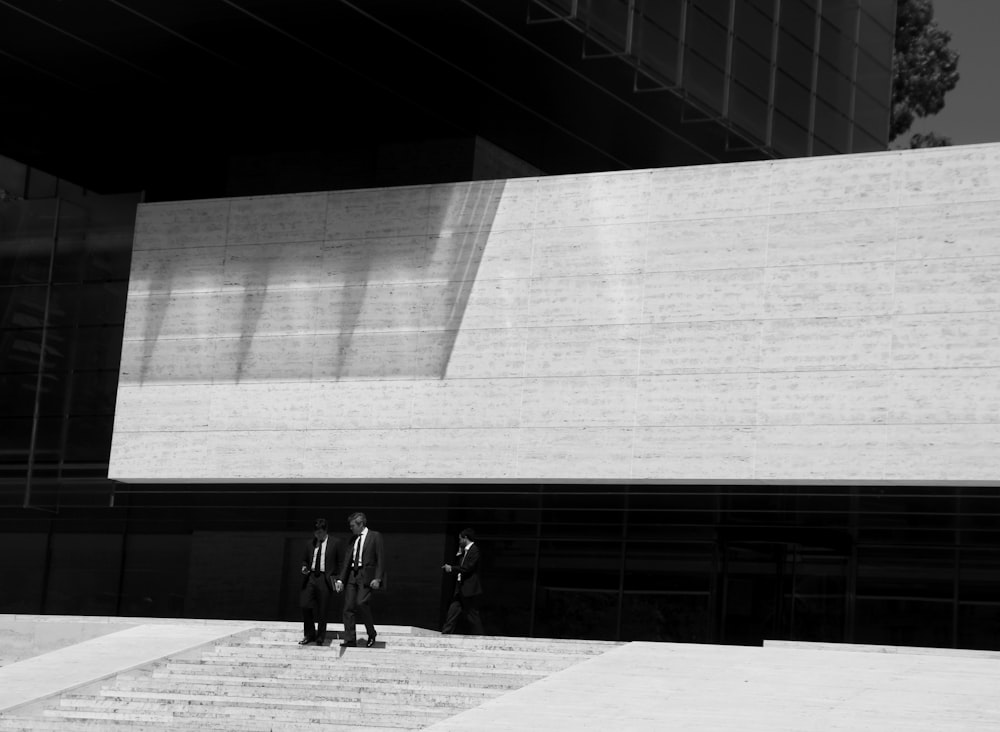 three men walking downstairs