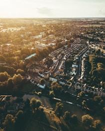 A vibrant aerial view of a well-planned township with homes, shops, parks, and roads interwoven.