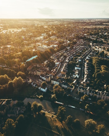 A vibrant aerial view of a well-planned township with homes, shops, parks, and roads interwoven.