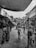 A bustling street market with locals and visitors interacting.