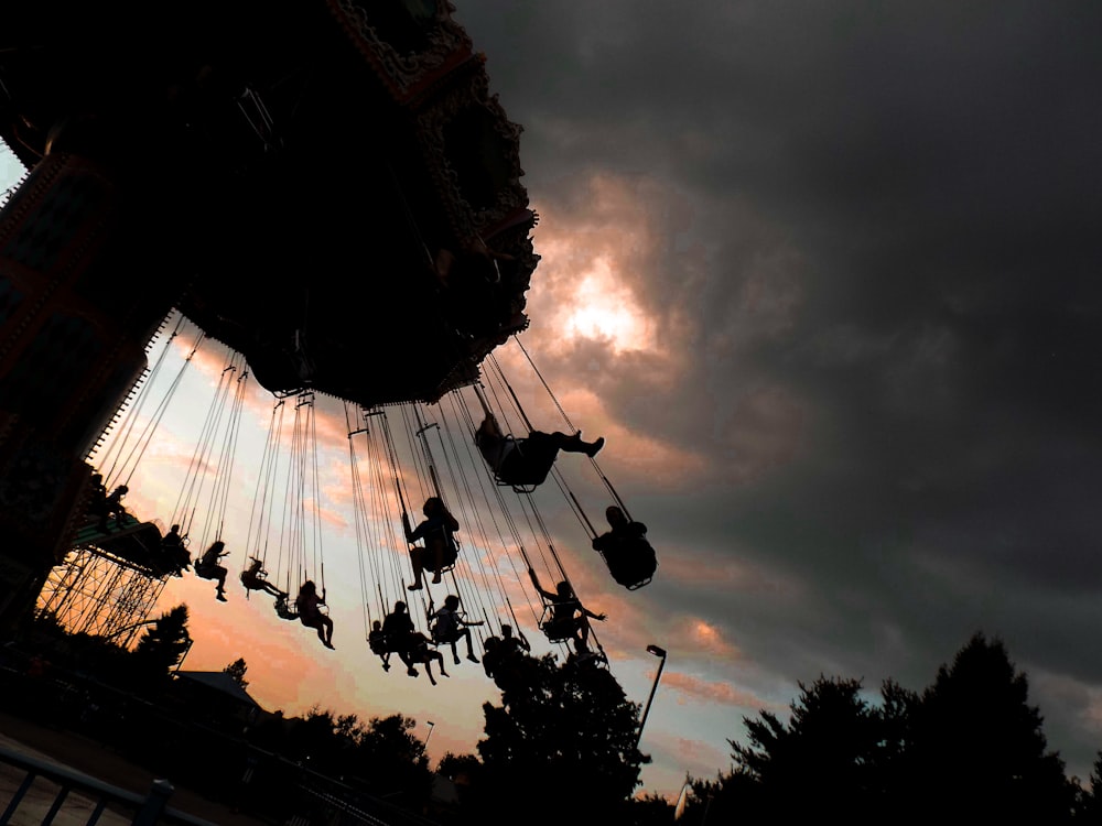 people sitting on amusement park ride