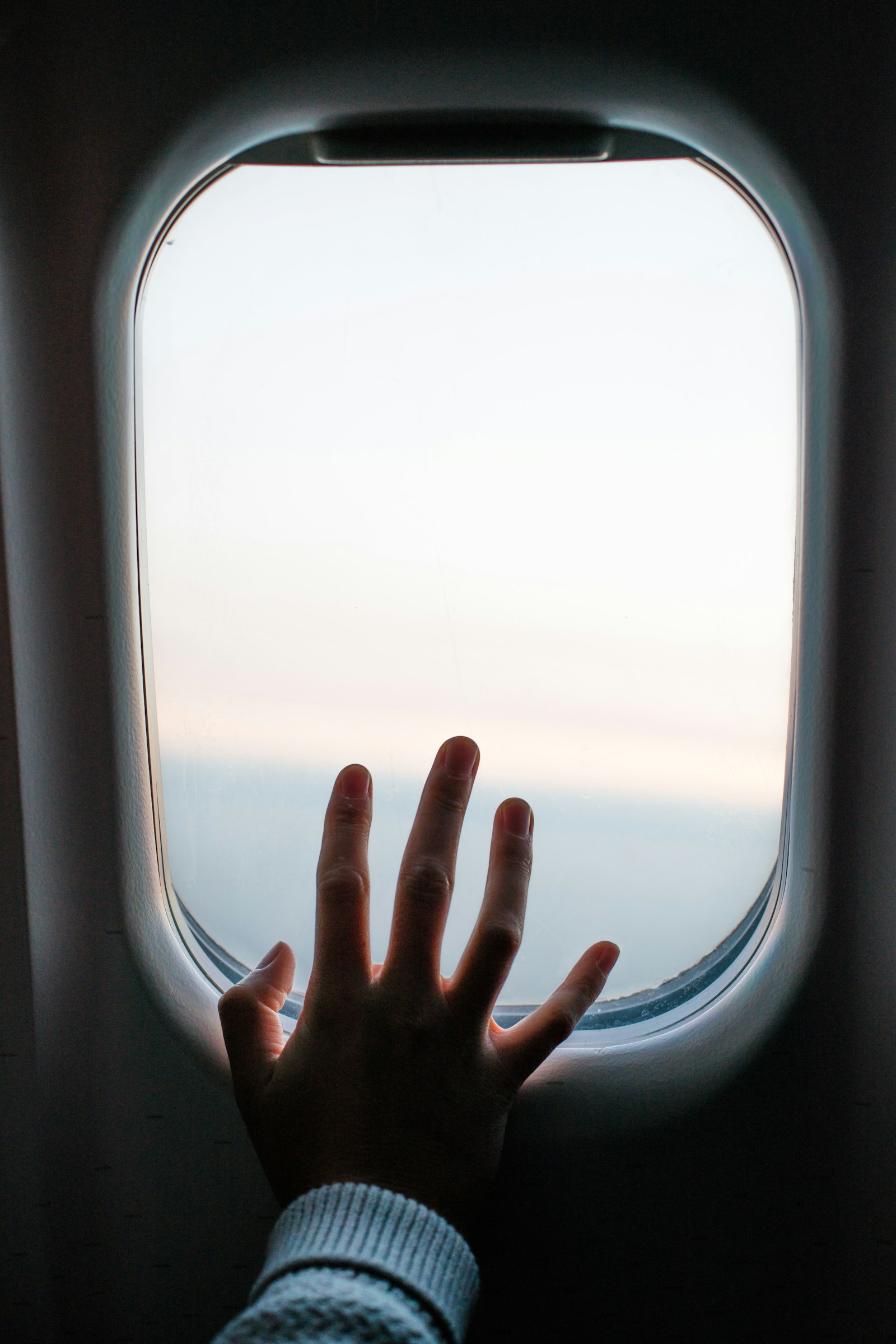 Sony a7R II + Canon EF 50mm F1.4 USM sample photo. Person touching airplane window photography