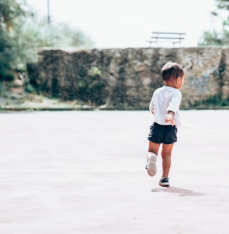 toddler running on gray concrete floor