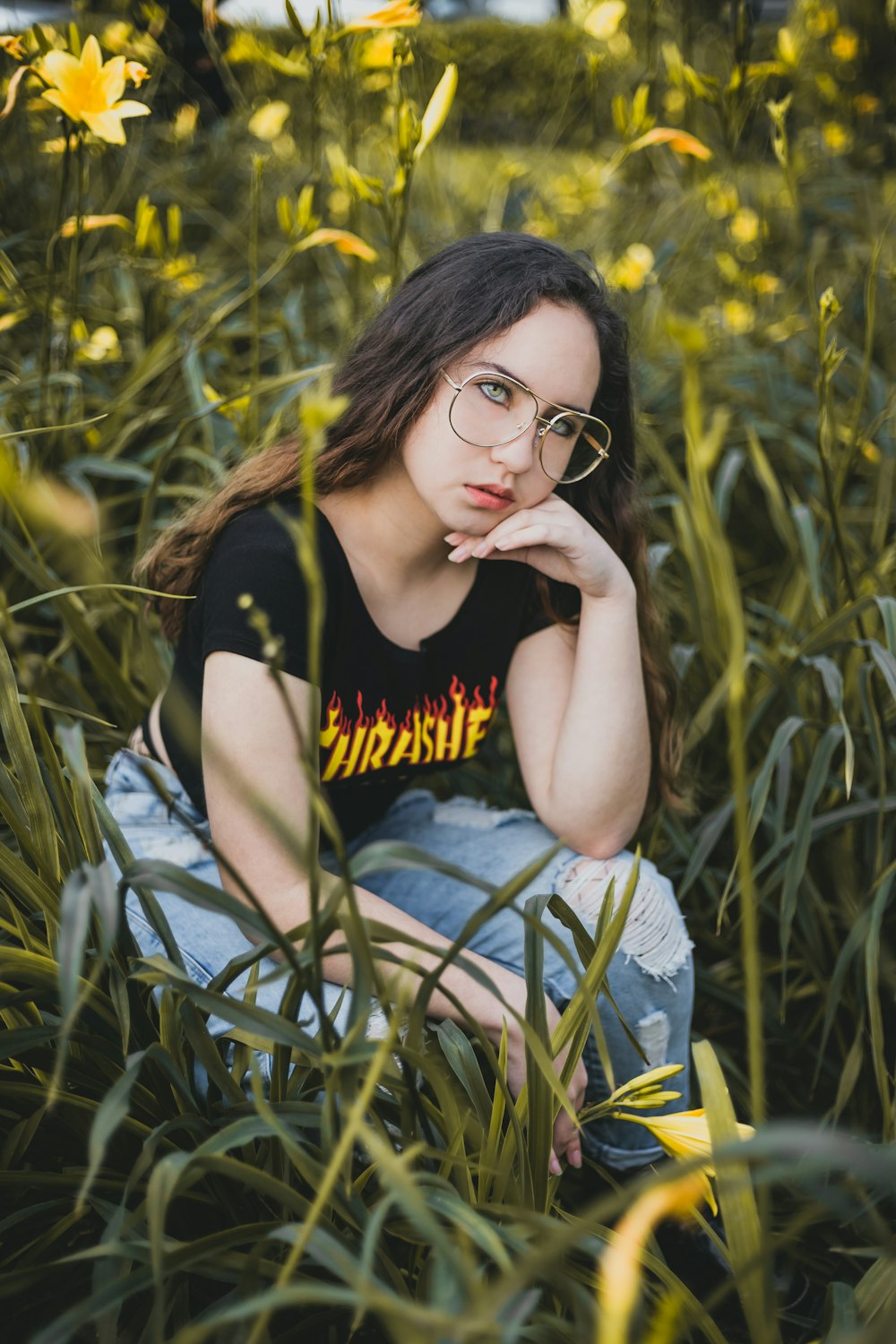 woman sitting on flower garden