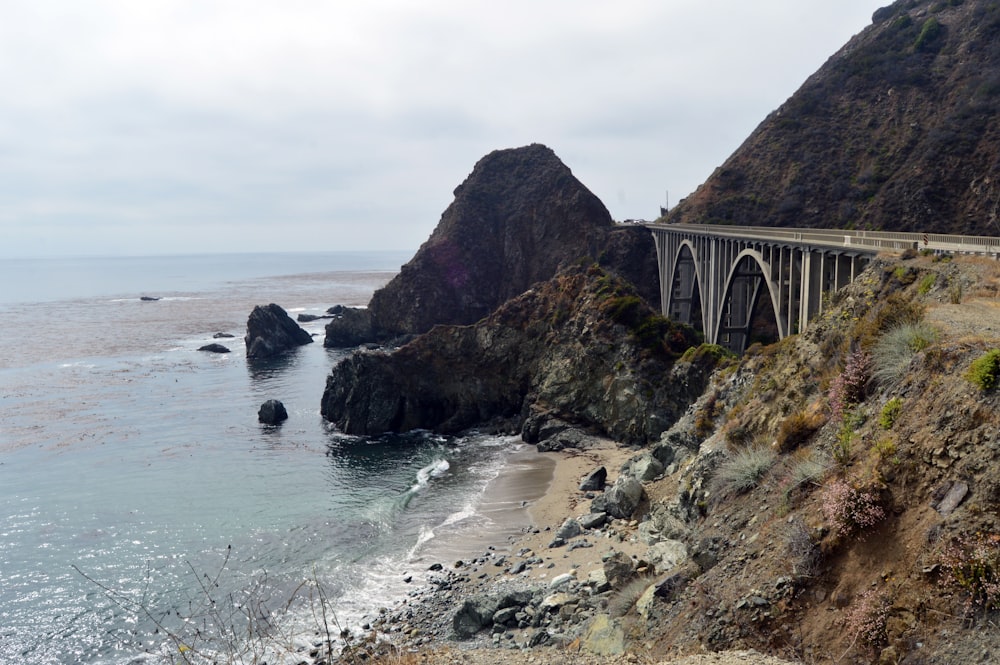 concrete bridge between mountain and sea